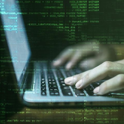 Zwei Hände tippen auf einer Notebook-Tastatur