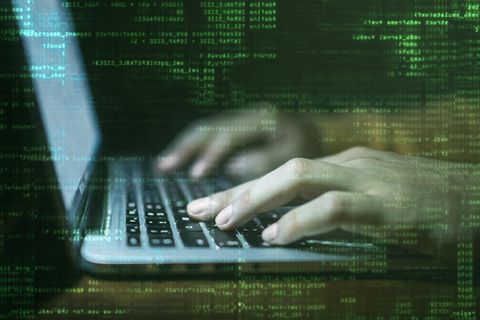 Zwei Hände tippen auf einer Notebook-Tastatur