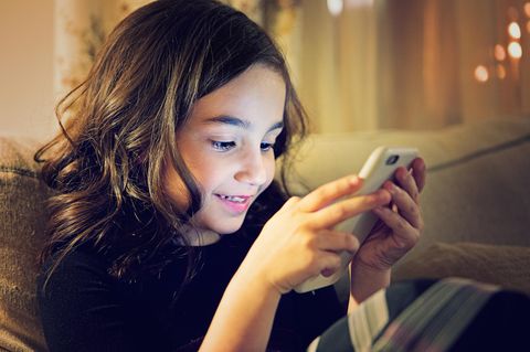 Ein Mädchen spielt auf ihrem Smartphone