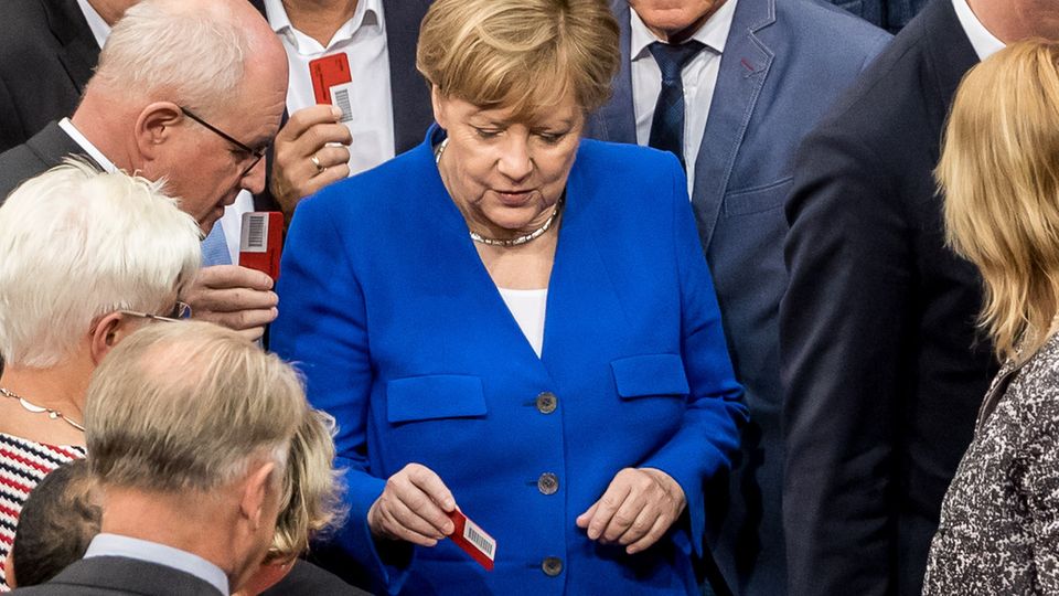 Angela Merkel gibt ihre "Nein"-Stimmkarte ab
