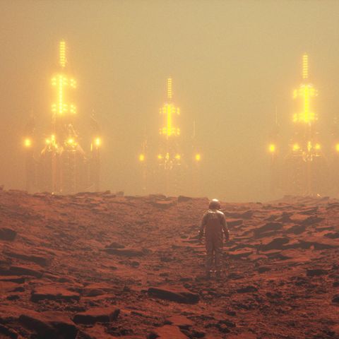 Eine Kolonie auf dem Mars im Sandsturm, davor eine Person im Raumanzug