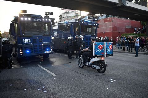 Ein Held bei der Arbeit: Dieser Pizzabote bahnt sich seinen Weg durch die "Welcome to Hell"-Demo gewaltbereiter G20-Gegner