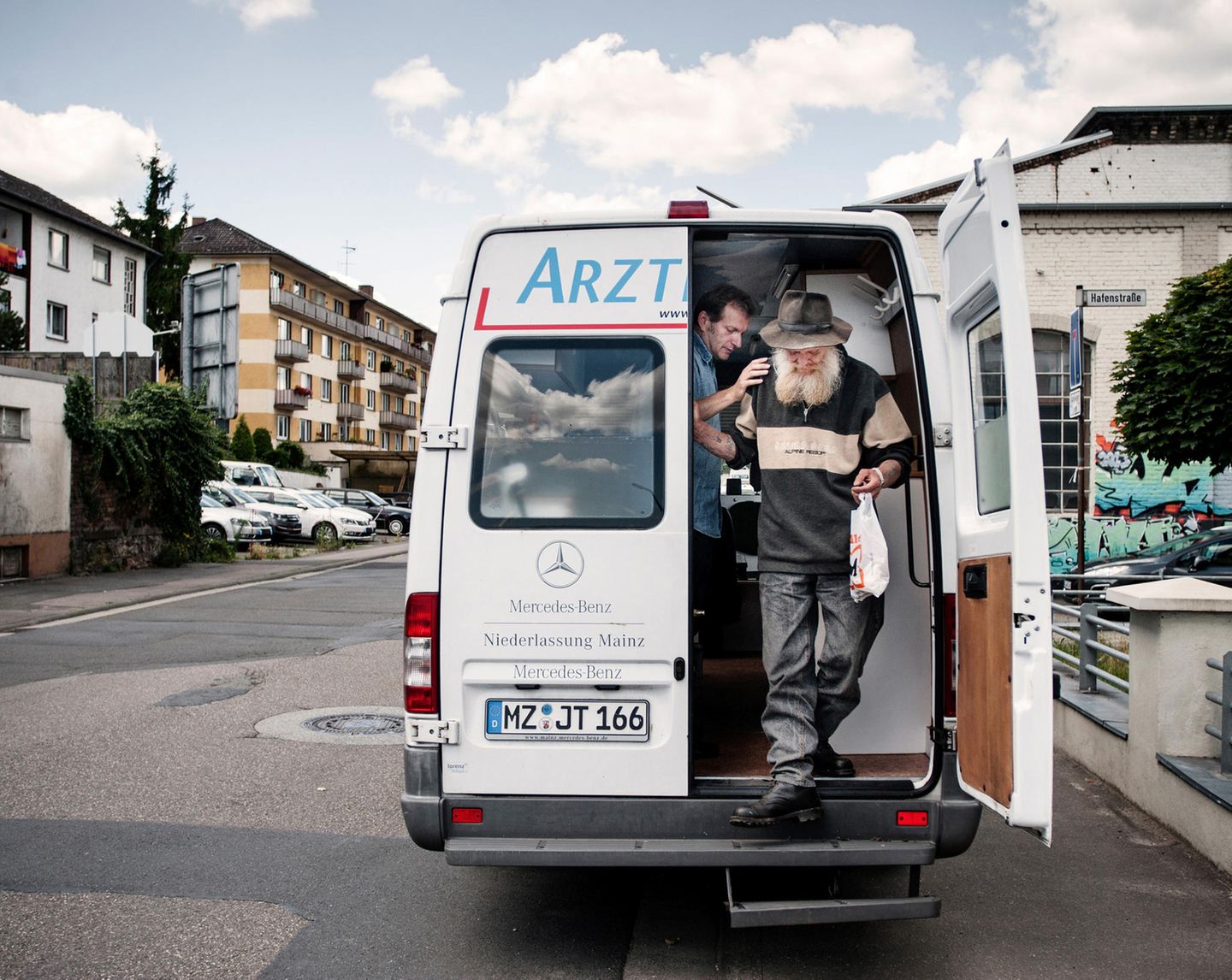 Gerhard Trabert - der "Arzt der Armen" Arztmobilsprechstunde in Bingen: "Der Feind ist schon längst in uns selbst, wenn wir die Menschen vergessen", sagt Sozialmediziner Gerhard Trabert (links). Mit dem Arztmobil fährt er mehrmals in der Woche zu bedürftigen Menschen. Gehwege und öffentliche Plätze werden zu Sprechzimmern.