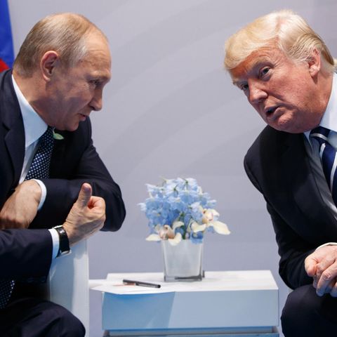 Russlands Präsident Wladimir Putin und US-Präsident Donald Trump beugen sich bei einem Gespräch zueinander