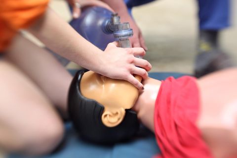 Ein Rettungssanitäter führt an einer Puppe eine Herz-Lungen-Massage durch