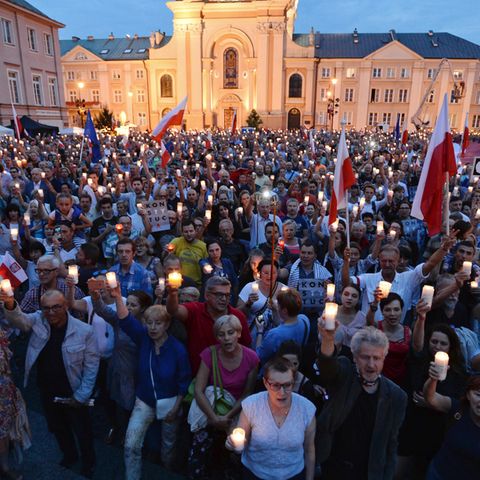 Menschen demonstrieren mit Lichtern gegen die geplante Justizreform in Polen