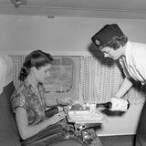 Darf es noch ein Schlückchen mehr sein? Kabinenservice der BOAC auf einem Flug von London nach Johannesburg in den frühen 50er Jahren.