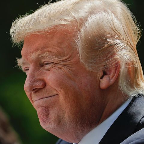 US-Präsident Donald Trump steht im Freien und lächelt zufrieden