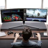 Ein Junger Mann sitzt vor seinem Samsung CHG90 Monitor