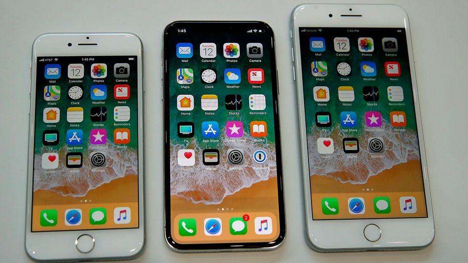 iPhone X, iPhone 8 und iPhone 8 Plus liegen nebeneinander auf einem Präsentationstisch