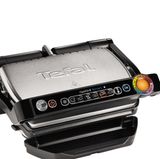 Tefal Optigrill  Sieht nicht so aus, ist aber einer: ein Grill. Genauer ein High-Tech-Grill, der die richtige Garstufe nicht dem Zufall überlässt. Der Tefal OptiGrill erkennt durch einen Sensor automatisch die Dicke des Grillguts und richtet den Grillvorgang danach aus. Über die sechs voreingestellten Grillprogramme passen sich Temperatur und Zeit optimal an die Art des Grillguts an. Die automatische Anzeige gibt im Farbkreis präzise an, in welcher Garstufe sich das Grillgut gerade befindet: egal ob blutig, medium oder "well-done". So werden Burger, Geflügel, Sandwiches, Würstchen, Steaks und Fisch stets punktgenau gegrillt und es bleibt mehr Zeit für die Gäste. Mit einer Grillfläche von 600 Quadratzentimetern lassen sich bis zu vier kleine Portionen gleichzeitig grillen.
