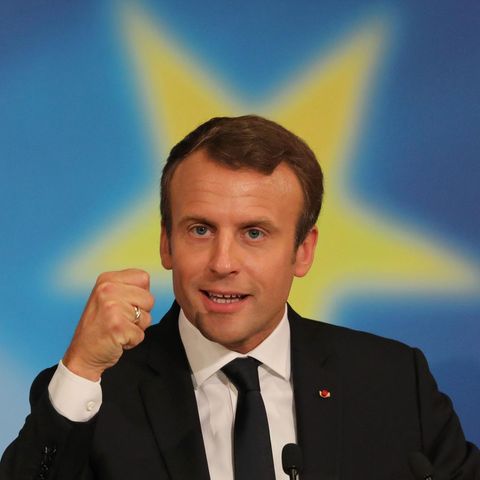Frankreichs Präsident Emmanuel Macron ballte Faust. Ein gelber Stern auf blauem Grund umgibt seien Kopf