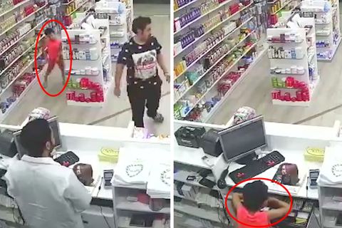 Kleiner Junge räumt die Kasse einer Apotheke leer