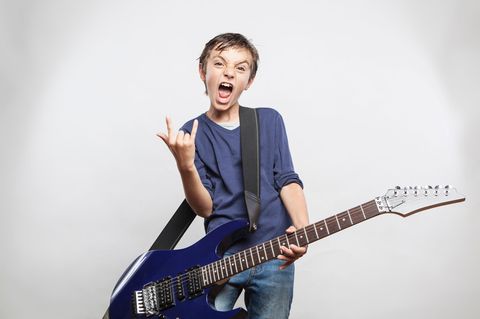 Ein Kind macht das Rockzeichen.