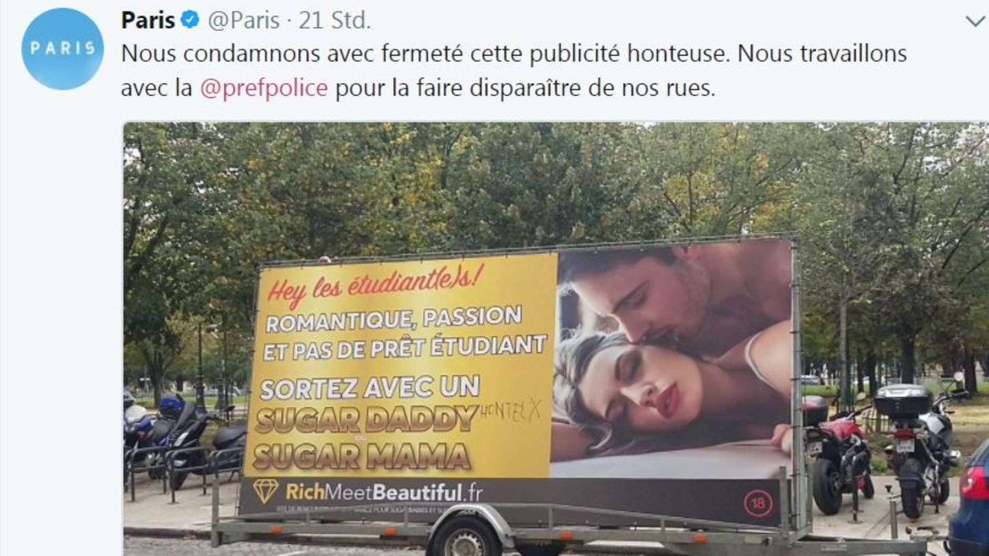Ein Anhänger mit einem Werbeplakat für ein Sugardaddy-Datingportal steht in Paris am Straßenrand