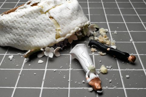 Eine Hochzeitstorte liegt zerstört auf deinem gekachelten Boden