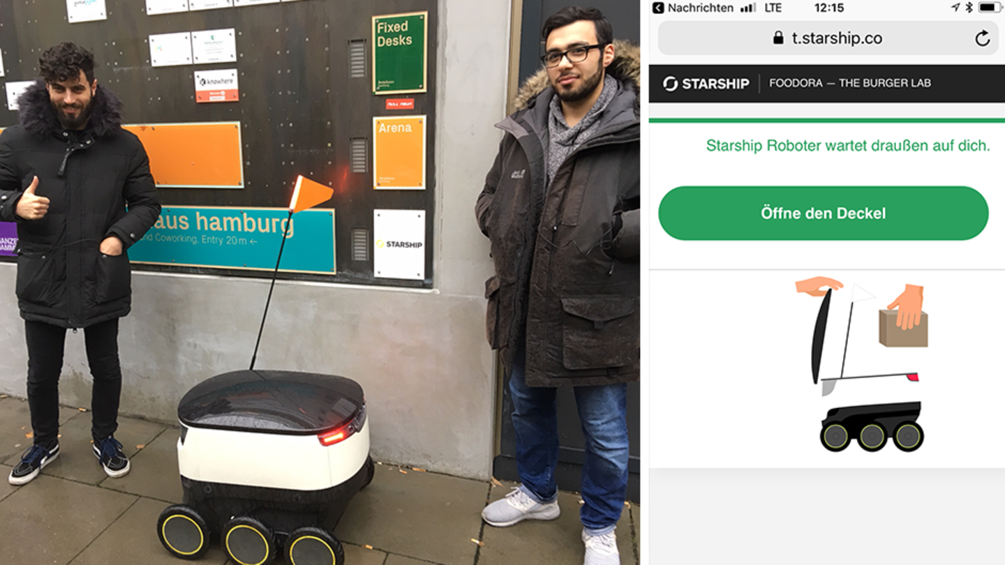 Ein Lieferroboter steht zwischen zwei Menschen