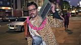 Merkmale des ultimativen Hipsters: ein Mantel, so hässlich, dass er schon fast wieder cool ist und ein Audiowiedergabegerät (das MacBook ist natürlich voll ironisch gemeint, weil Kapitalismus und so), mit dem sonst niemand auf der Straße zu sehen ist. So individuell!