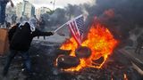 Demonstranten zünden eine US-Flagge an