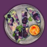 Wurzel-Tortilla  Zutaten:  20 g Mandeln, 60 g Schalotten, halbiert, 200 g rote Paprika, entkernt, in Stücken, 40 g Weißweinessig, 80 g Olivenöl, 1025 g Wasser, 2 ¼ TL Salz, 4 Prisen Pfeffer, 1 Bio-Zitrone,, ½ TL Schale fein abgerieben, Saft ausgepresst, 130 g lila Möhren, in Scheiben (3 mm), 150 g Pastinaken, in Scheiben (3 mm), 50 g Zwiebeln, halbiert, 30 g Sahne, 5 Eier (Kl. M), 6 Stängel Petersilie, abgezupft, ¼ TL Paprikapulver rosenscharf, 2 Prisen Muskatnuss      Zubereitung:  1. Mandeln und Schalotten in den Mixtopf geben und 4 Sek./Stufe 5 zerkleinern.    2. Paprikastücke zugeben, 2 Sek./Stufe 5 zerkleinern und mit dem Spatel nach unten schieben.    3. Weißweinessig, 60 g Öl, 25 g Wasser, ¼ TL Salz, 2 Prisen Pfeffer und Zitronenschale zugeben, 20 Sek./Stufe 3 verrühren und in eine kleine Servierschüssel umfüllen. Mixtopf ausspülen.    4. 500 g Wasser in den Mixtopf geben, Varoma-Behälter aufsetzen, Möhren und Pastinaken einwiegen, mit ½ TL Salz würzen und 10 Min./Varoma/Stufe 1 garen. In dieser Zeit Varoma-Einlegeboden mit Backpapier auslegen, dabei darauf achten, dass die oberen seitlichen Schlitze frei bleiben.    5. Varoma absetzen, Gemüse gut abtropfen und ausdämpfen lassen.  Mixtopf leeren.    6. Zwiebeln in den Mixtopf geben, 5 Sek./Stufe 5 zerkleinern und mit dem Spatel nach unten schieben.    7. 20 g Öl zugeben und 3 Min./120 °C/ Stufe 1 (3 Min./Varoma/Stufe 1) dünsten.    8. Sahne, Eier, zerkleinerte Petersilie, bis auf ein paar Blätter, ½ TL Salz, 2 Prisen Pfeffer, Paprikapulver und Muskat zugeben und 15 Sek./Stufe 3 verrühren. Mischung auf den vorbereiteten Varoma-Einlegeboden geben, gedämpftes Gemüse darauf verteilen, in den Varoma-Behälter einsetzen und Varoma verschließen.    9. 500 g Wasser und 1 TL Salz in den Mixtopf geben, Varoma aufsetzen und 25 Min./Varoma/Stufe 1 garen. Tortilla mit Paprika-Vinaigrette und restlicher Petersilie bestreuen und servieren.