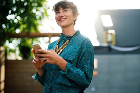 Lächelnde Frau mit Mobiltelefon