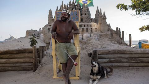 Der Brasilianer Marcio Mizael Matolias sitzt auf einem Holzstuhl vor seiner Strandburg in Rio.