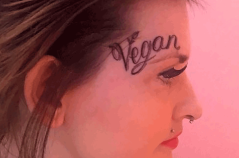 Ein Frauengesicht, auf dessen Stirn ein "Vegan" tätowiert ist