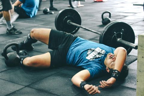 Ein Mann liegt im Fitnessstudio am Boden