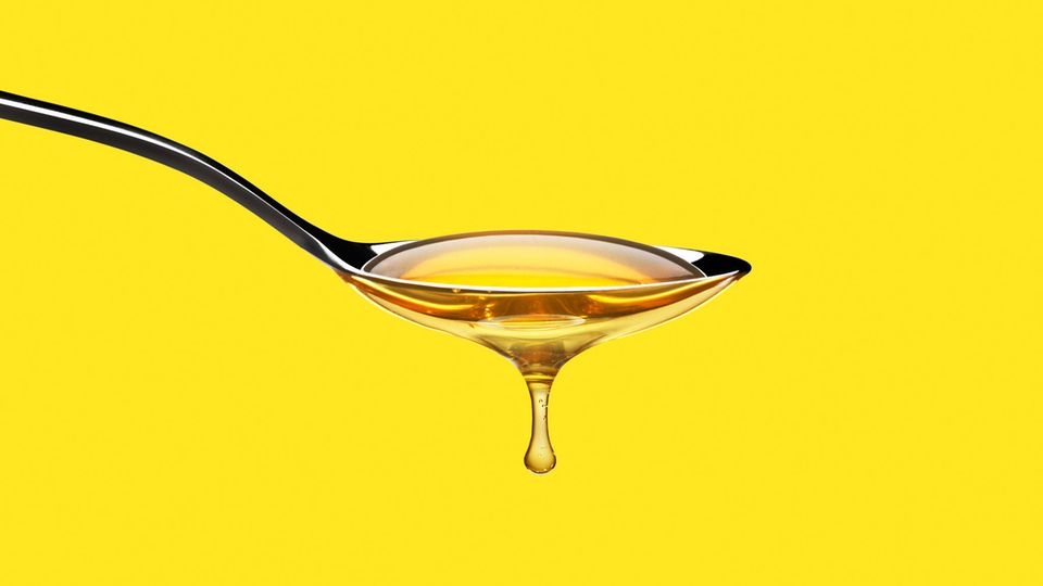 A spoon with honey dripping from it