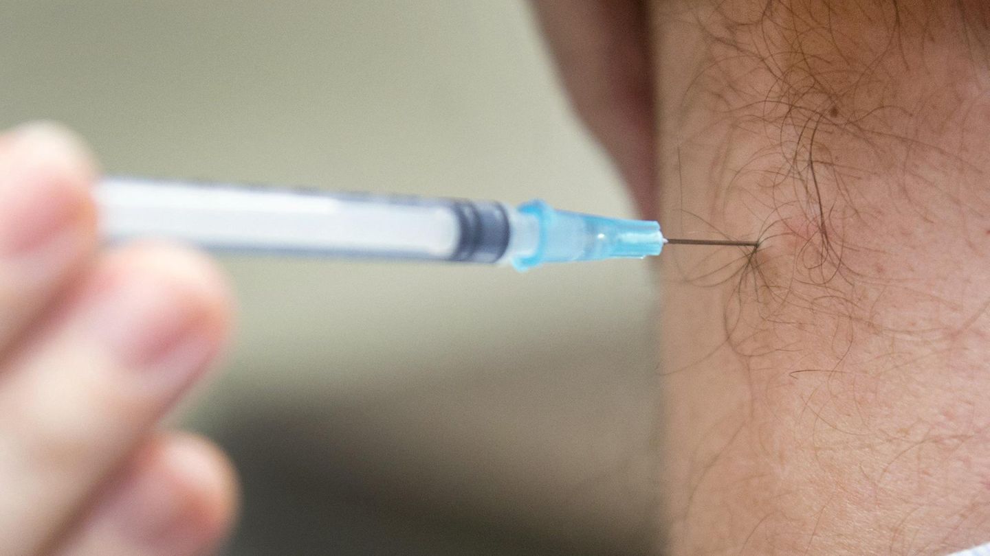 Ein Mann wird gegen Grippe geimpft