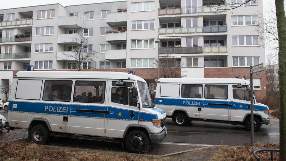 Polizeifahrzeuge stehen vor einem Gebäudekomplex in Alt-Hohenschönhausen