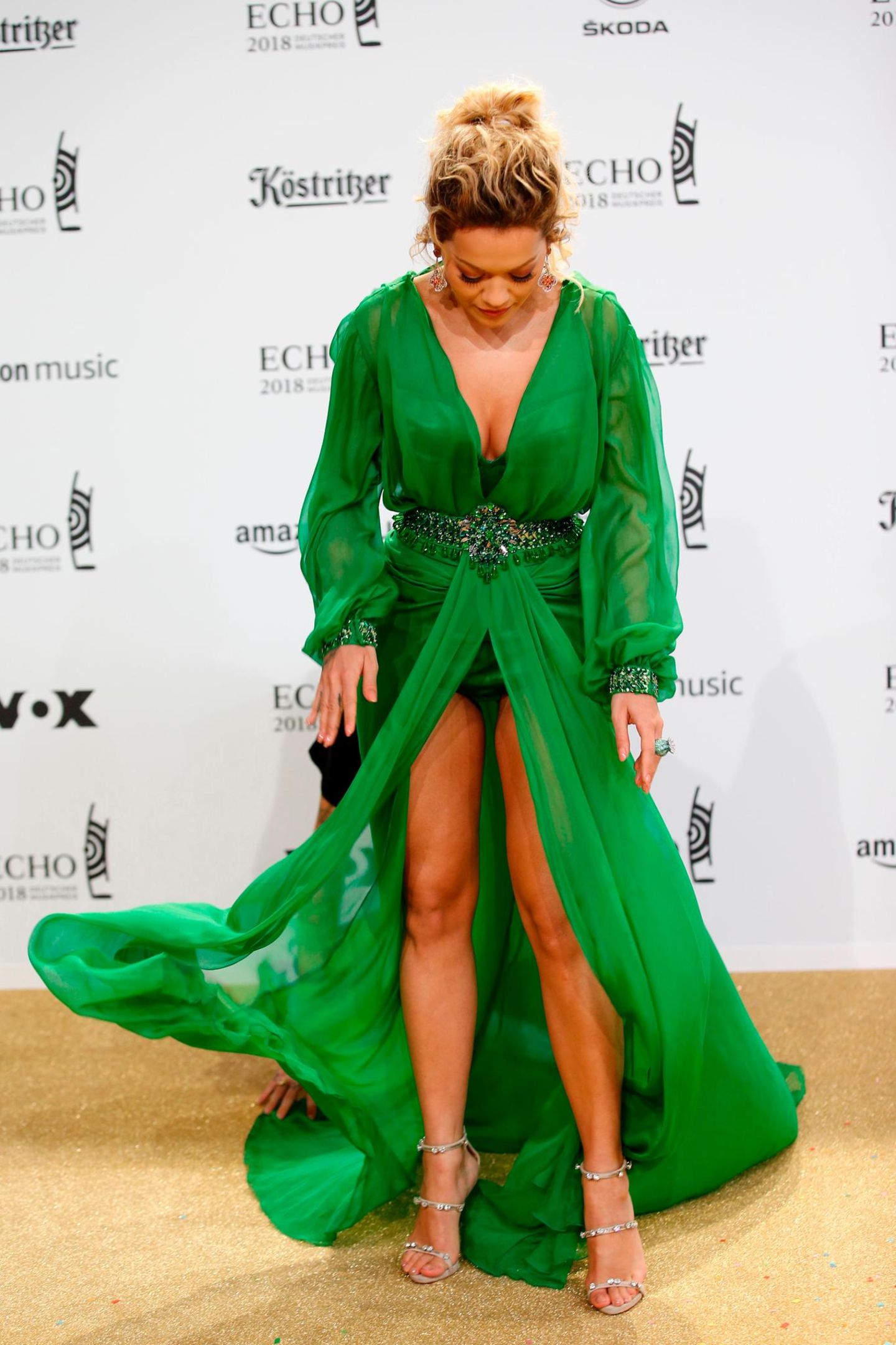 Sitzt, wackelt und hat Luft: Sängerin Rita Ora hat mit den Tücken ihres grünen Designerkleides zu kämpfen. Gut, dass sie später auf der Bühne Hosen trug.