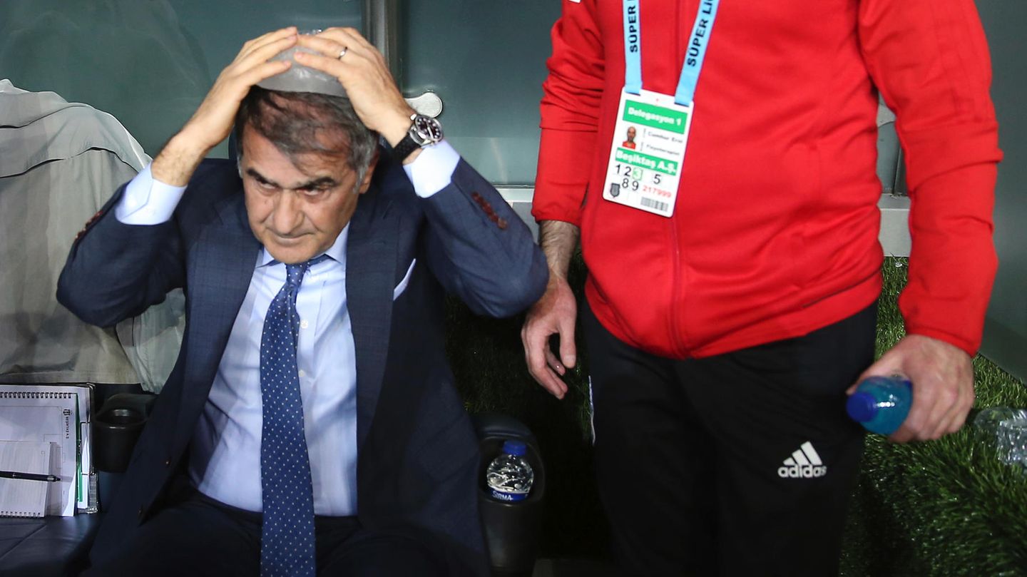 Senol Günes, Trainer von Besiktas, sitzt mit einem Eisbeutel auf der Bank