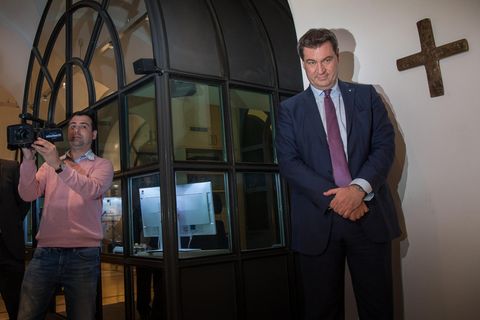Markus Söder und Journalisten vor dem Kreuz in der Münchner Staatskanzlei