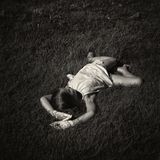 Mädchen liegt in Gras