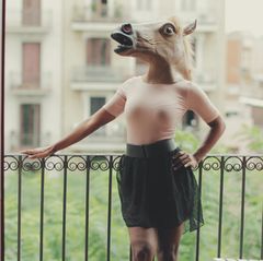 Eine Frau steht auf dem Balkon. Vielleicht ist ja gerade auf Wohnungssuche?