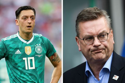DFB-Präsident Reinhard Grindel (r.) erwartet, dass Mesut Özil (l.) sich nach dem Urlaub öffentlich äußert
