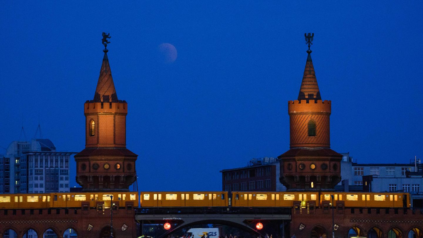 Berlin: Der Vollmond taucht über der Oberbaumbrücke auf, während eine U-Bahn die Brücke überquert