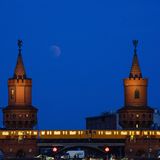 Berlin: Der Vollmond taucht über der Oberbaumbrücke auf, während eine U-Bahn die Brücke überquert
