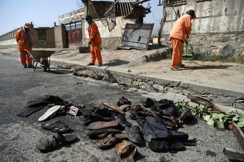 Nach einem Anschlag in Afghanistans Hauptstadt Kabul räumen Männer die Straßen auf