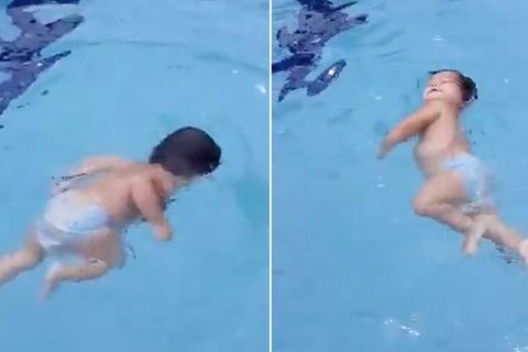 Ganz allein im Pool: Einjähriges Mädchen schwimmt allein zum Beckenrand und zieht sich aus dem Wasser