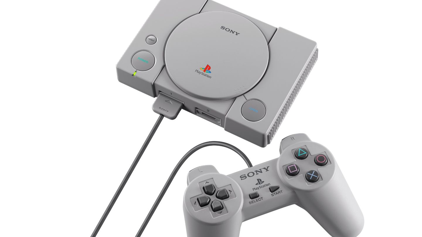 Graue Playstation-Spielekonsole mit Kontrollern