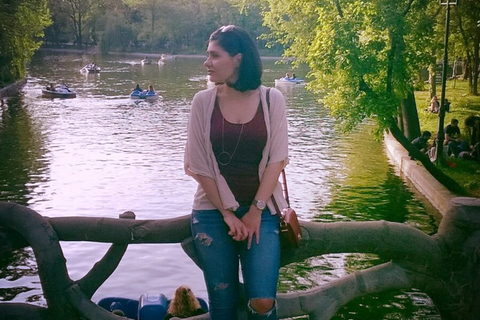 Frau sitzt auf Baumstamm vor See