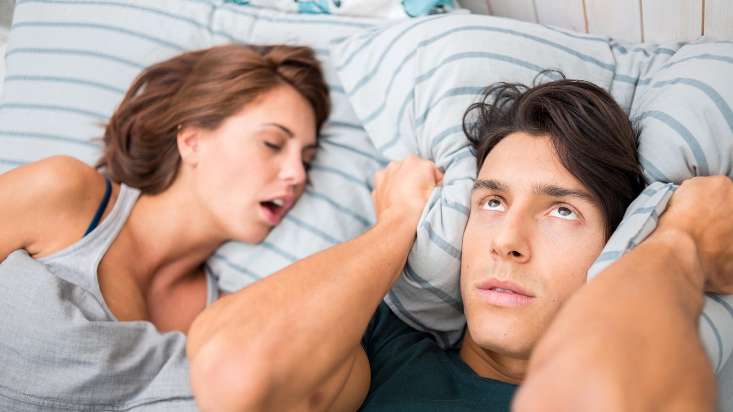 Frau schnarcht und Mann kann nicht schlafen