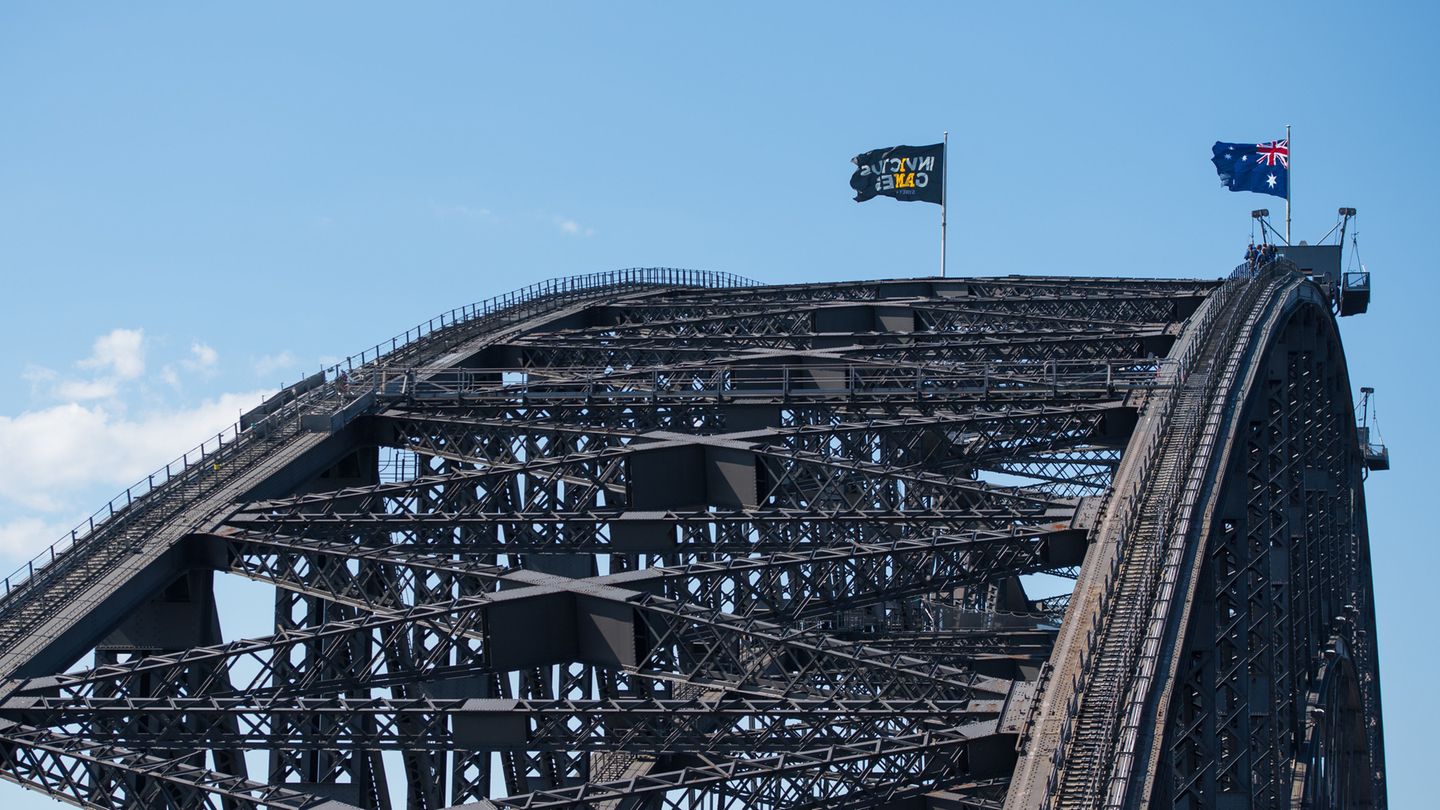 Auf dem höchsten Punkt der Brücke hisste Harry die Flagge der Invictus Games. Der Prinz rief die Sportveranstaltung für kriegsversehrte Soldaten 2014 ins Leben. Vom 20. bis 27. Oktober werden die Wettbewerbe in Sydney ausgetragen.