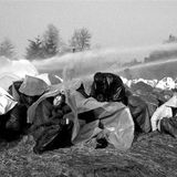 Demonstranten unter Planen gegen die Wasserwerfer
