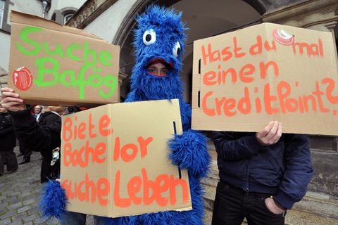 Krümelmonster hält Schild