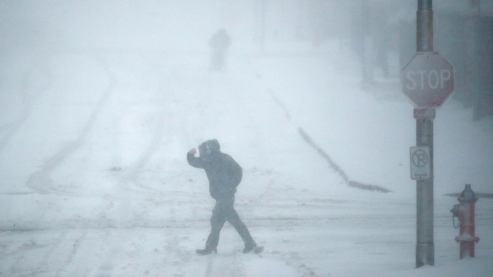 Schneetreiben USA Ein Fußgänger geht in Kansas City bei Schneetreiben über eine Straße.