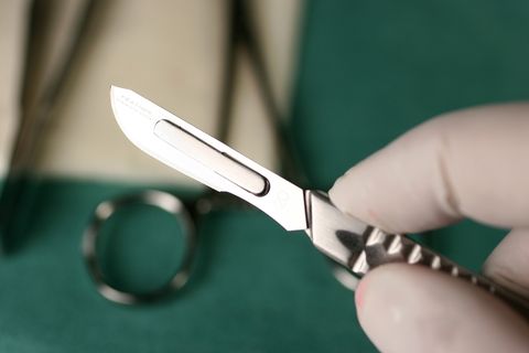 Ein Arzt hält ein Skalpell in der Hand