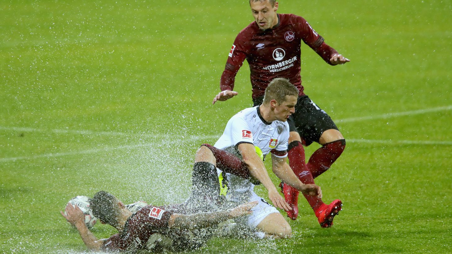 Lars Bender (m.) haut sich voll rein gegen die Nürnberger Leibold (l.) und Hanno Behrens (r.):  Bei den Wasserspielen von Nürnberg war Leverkusen die bessere Mannschaft, verpasste aber den Siegtreffer gegen tapfer kämpfende Franken